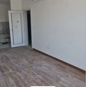 Prazna prostorija u novogradnji sa postavljenim podovima i bijelim zidovima. - image 3