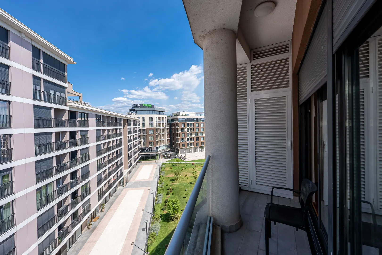 View from the balcony overlooking the courtyard and surrounding residential buildings.