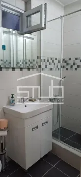 Compact bathroom with a vanity sink, mirror, and a shower cabin. - image 14