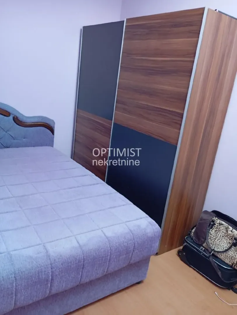 Bedroom with a double bed and a large wardrobe.
