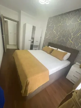 Furnished bedroom with a double bed and wardrobe. - image 6
