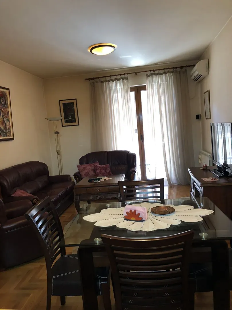 A living room with leather furniture and a dining table.