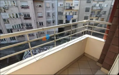 Small tiled balcony with a metal railing and a view of neighboring buildings. - image 21
