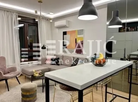 Living room with a sofa and dining table. - image 2