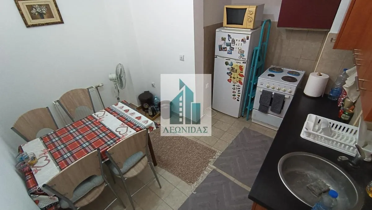 Kitchen with a dining table and chairs.