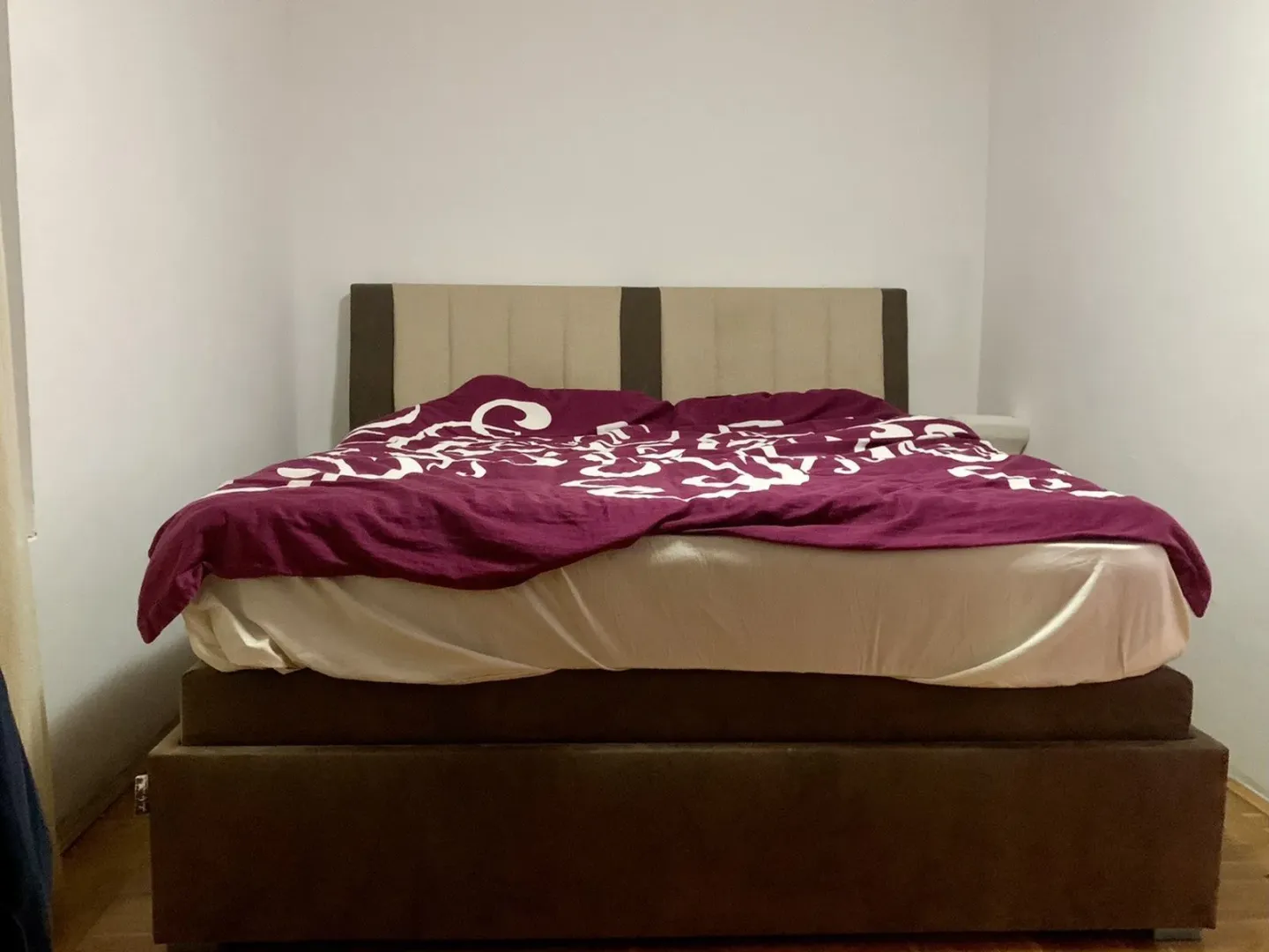 A simply furnished bedroom featuring a large double bed.