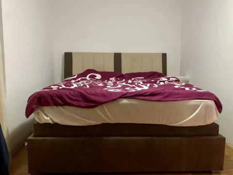 A simply furnished bedroom featuring a large double bed. - image 11