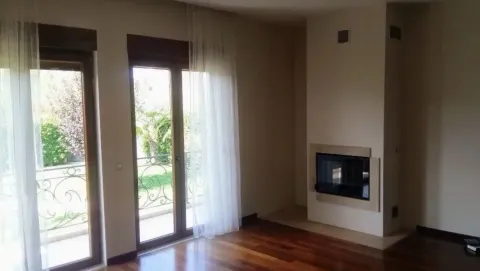 Living room with a fireplace and access to the terrace. - image 7