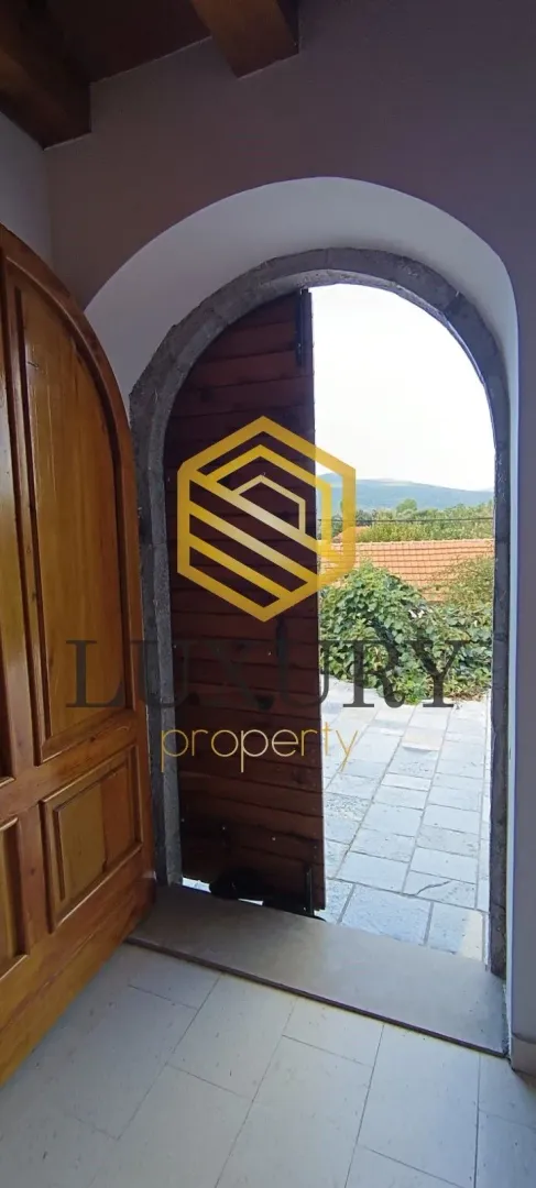 View through a traditional wooden door towards the courtyard and nature.
