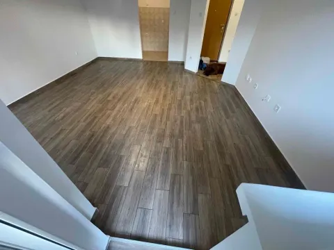 Empty living room with wood flooring. - image 7