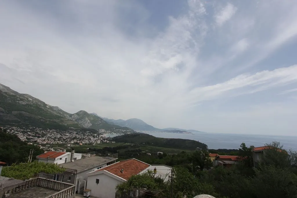 Panoramic view of the sea and surrounding hills.