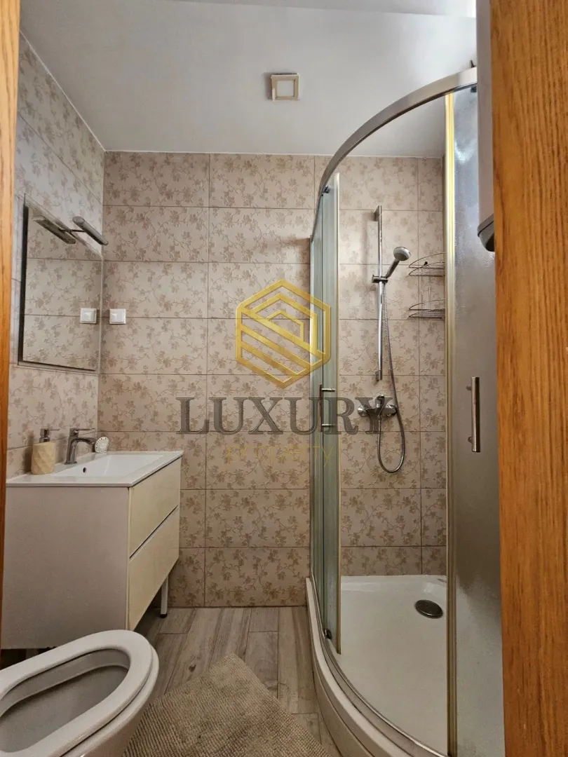 Manje kupatilo sa tuš kabinom, umivaonikom i wc šoljom.