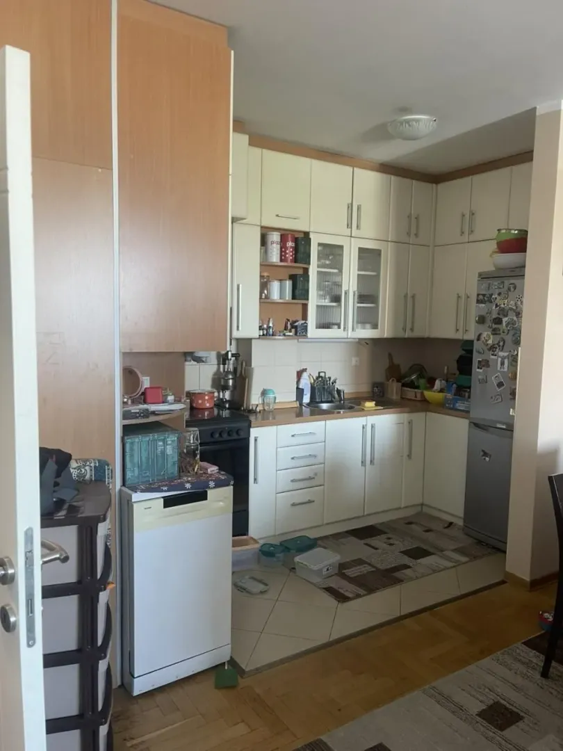 Kitchen with wooden cabinetry, a sink, and built-in appliances.