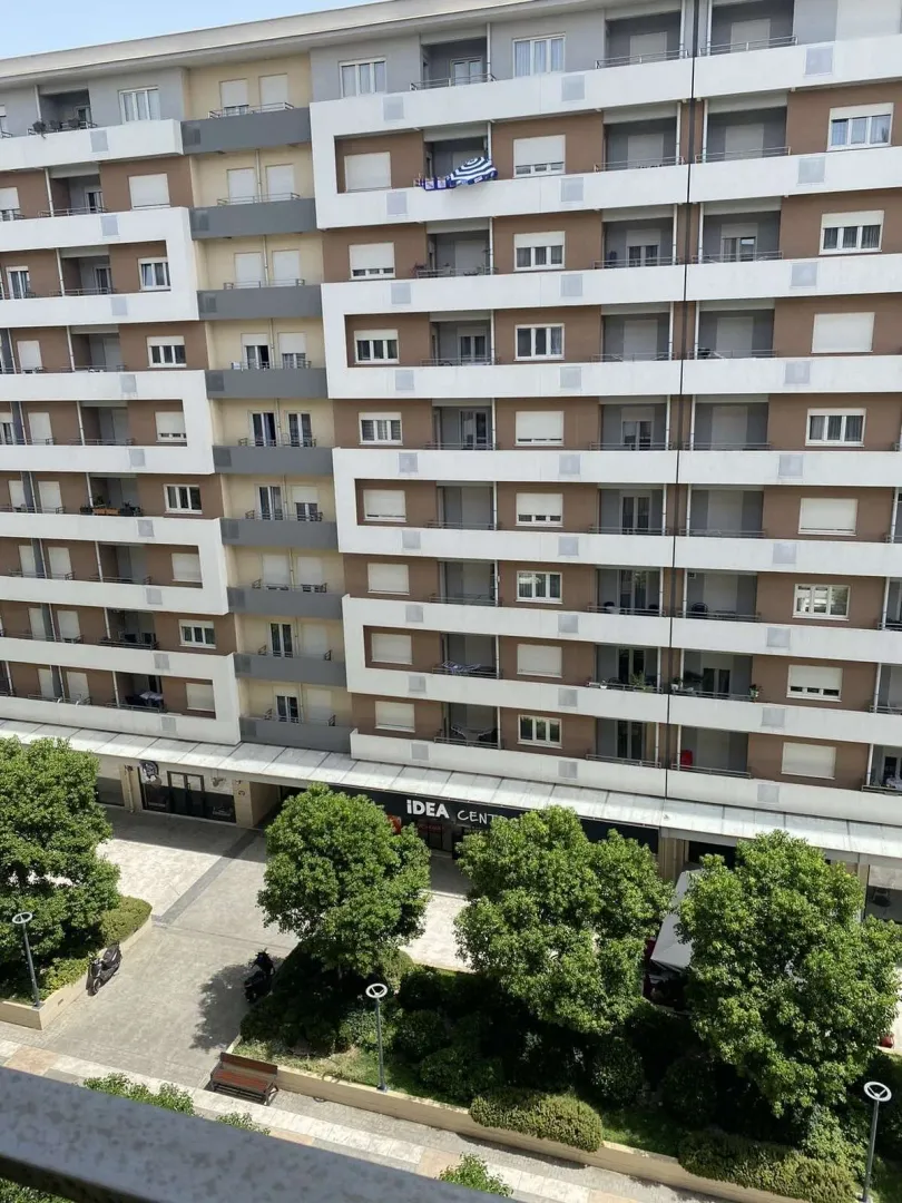High-angle view of a residential building facade and a landscaped courtyard.
