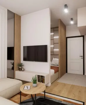 Moderan enterijer dnevnog boravka sa TV-om i pogledom na spavaću sobu. - image 3