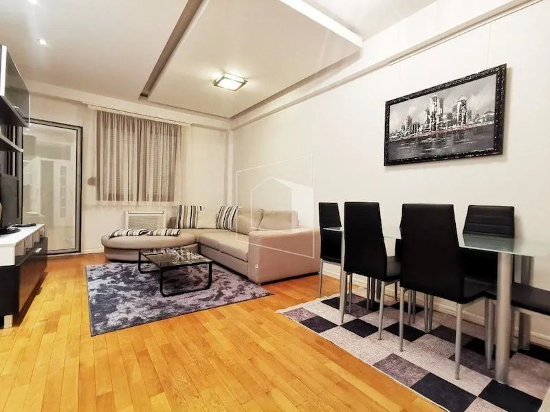 Living room with a sofa and a dining table.