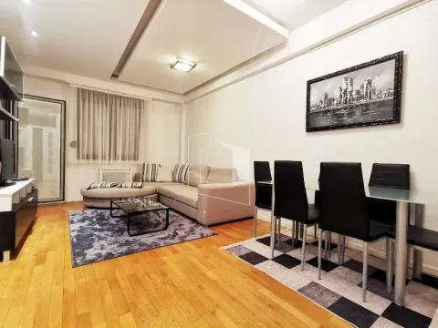 Living room with a sofa and a dining table. - image 3