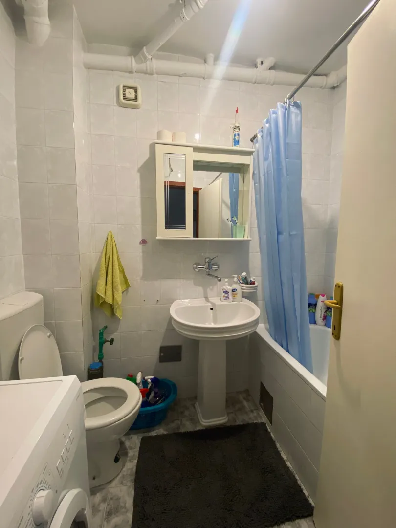 Small bathroom with a sink, toilet, and bathtub.