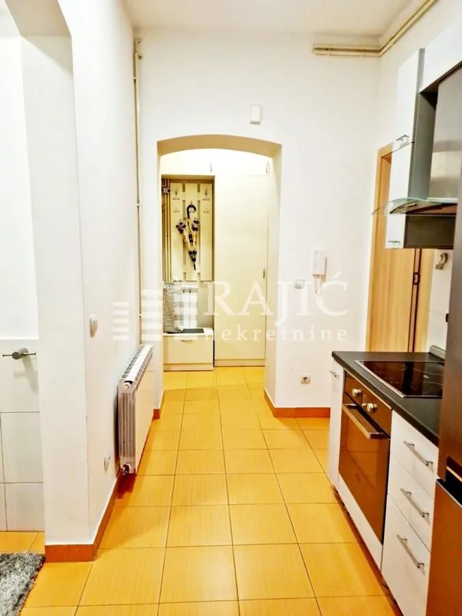 Hallway with a kitchen in light tones.