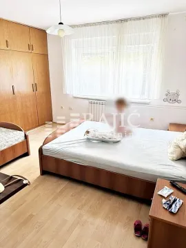 Bedroom with a double bed, wardrobe, and window. - image 2