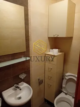 Smaller bathroom with a sink, toilet, and cabinet. - image 8