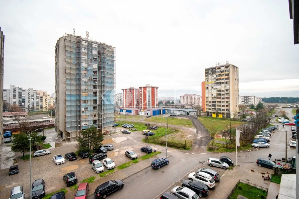View from the apartment overlooking surrounding residential buildings and parking.
