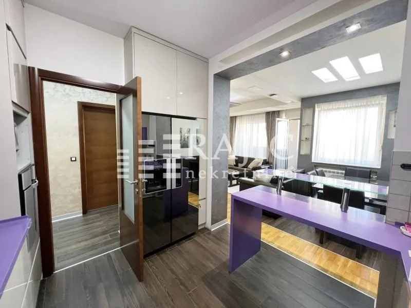 Modern kitchen connected to the dining room and living room.