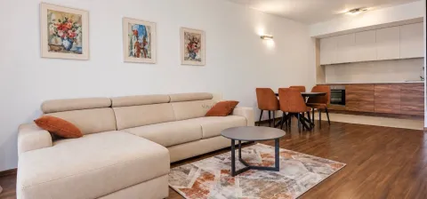 Spacious living room with a sofa set, dining area, and kitchen in the background. - image 2