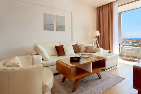 Living room with a sofa, coffee table, and access to the terrace. - image 6