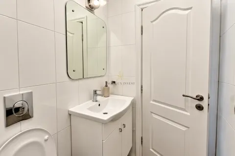 View of a modernly equipped bathroom with a washbasin and a mirror. - image 8