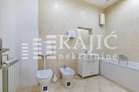 Fully equipped bathroom with a bathtub, washbasin, and sanitary fixtures. - image 9