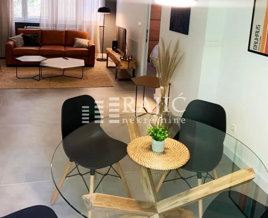 View of the dining area and living room with modern furniture.