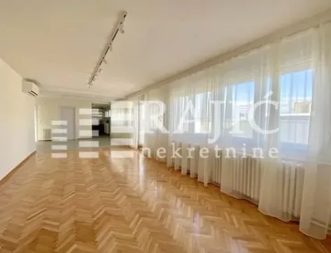 Spacious empty room with parquet flooring and large windows covered with curtains. - image 3