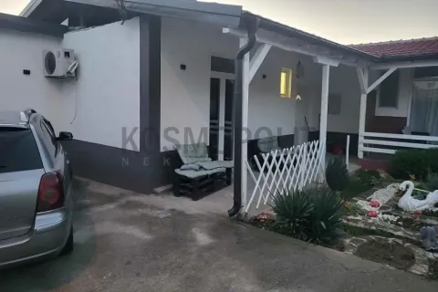 View of the exterior of the house with a covered terrace and landscaped yard. - image 2