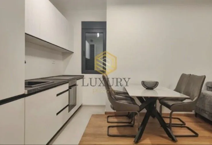 Modern kitchen with dining area and built-in appliances.