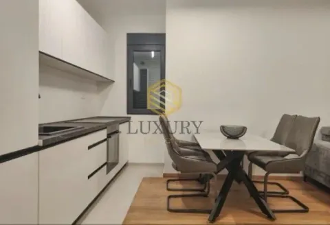 Modern kitchen with dining area and built-in appliances. - image 5