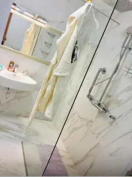 Modern bathroom with a walk-in shower tiled in marble. - image 8