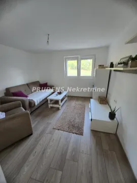 Living room with sofa seating, coffee table, and TV cabinet. - image 2
