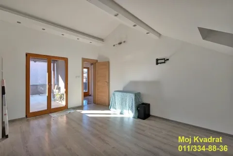 Empty room with wooden flooring, drop ceiling, and access to a terrace. - image 8