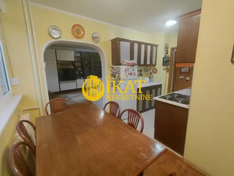 Dining area with a wooden table and chairs connected to the kitchen. - image 11