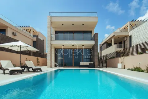 Modern villa with a swimming pool and landscaped yard. - image 5