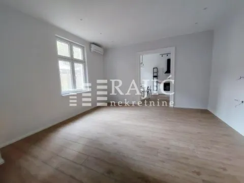 Empty room with laminate flooring and a window, looking into another room. - image 15