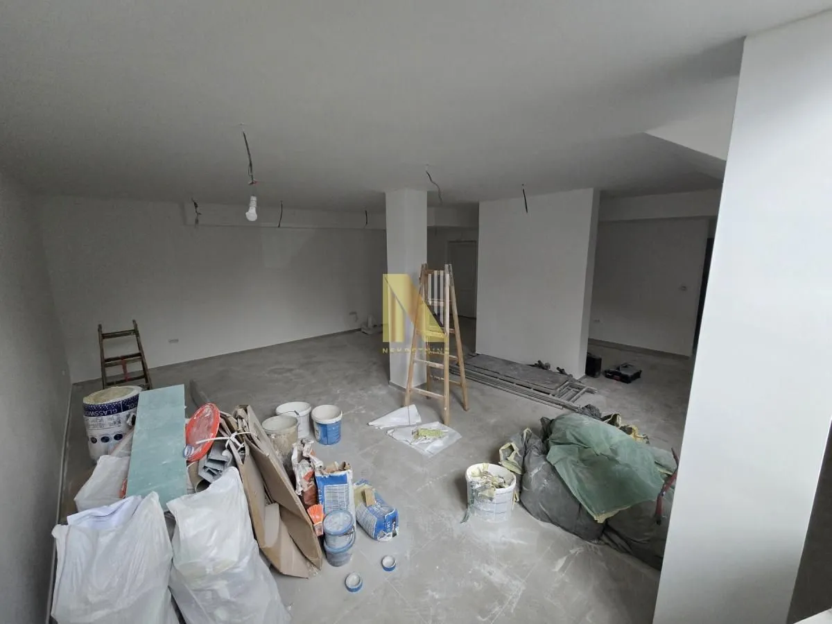 Empty room under renovation with construction materials.