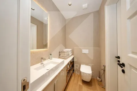 Modern bathroom equipped with a washbasin and toilet. - image 15