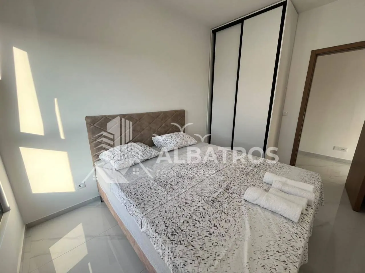 Furnished bedroom with a double bed and built-in wardrobe.