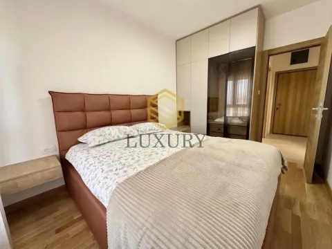 Furnished bedroom with a double bed, wardrobe, and wooden flooring. - image 6