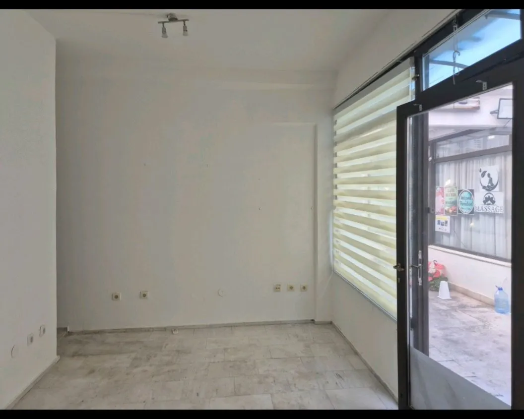 Empty bright room with white walls and access to the terrace.