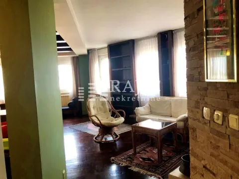 Living room with seating furniture and stone wall details. - image 18