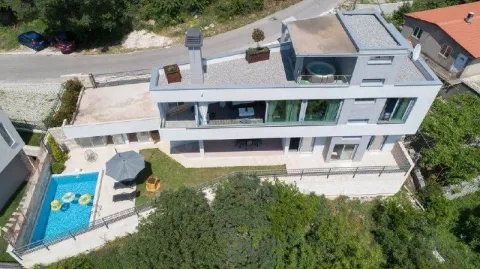 Aerial view of a modern villa with a swimming pool and landscaped yard. - image 7