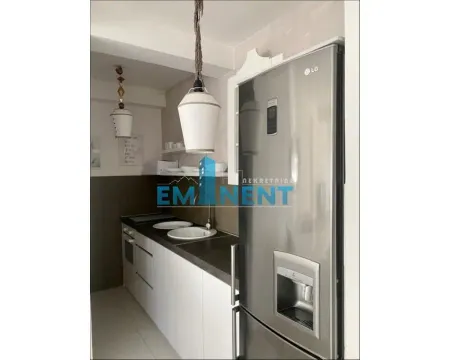 Small kitchen with white units and a built-in refrigerator. - image 5